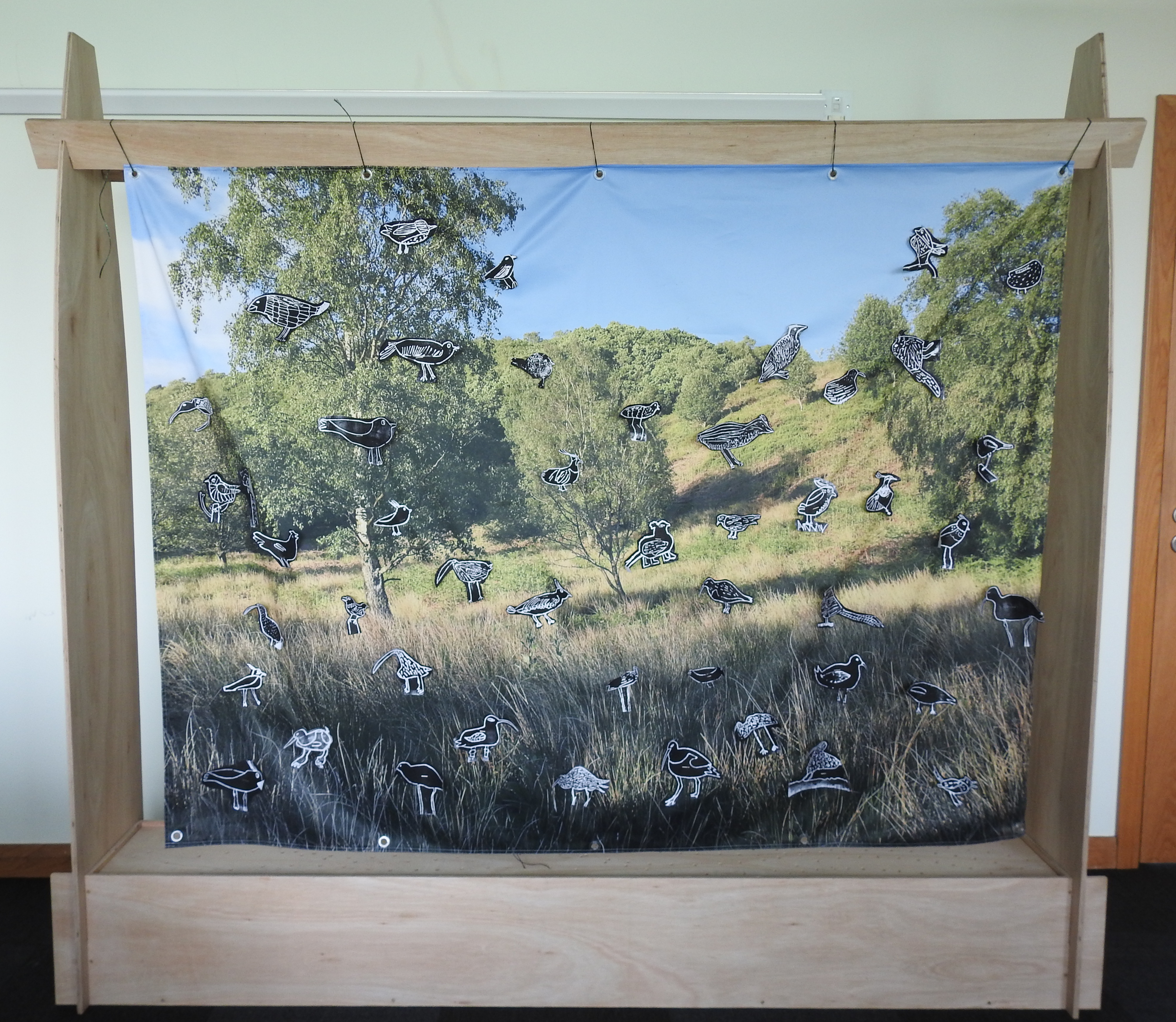 Fabric display showing fieldwork location with conductive bird prints attached